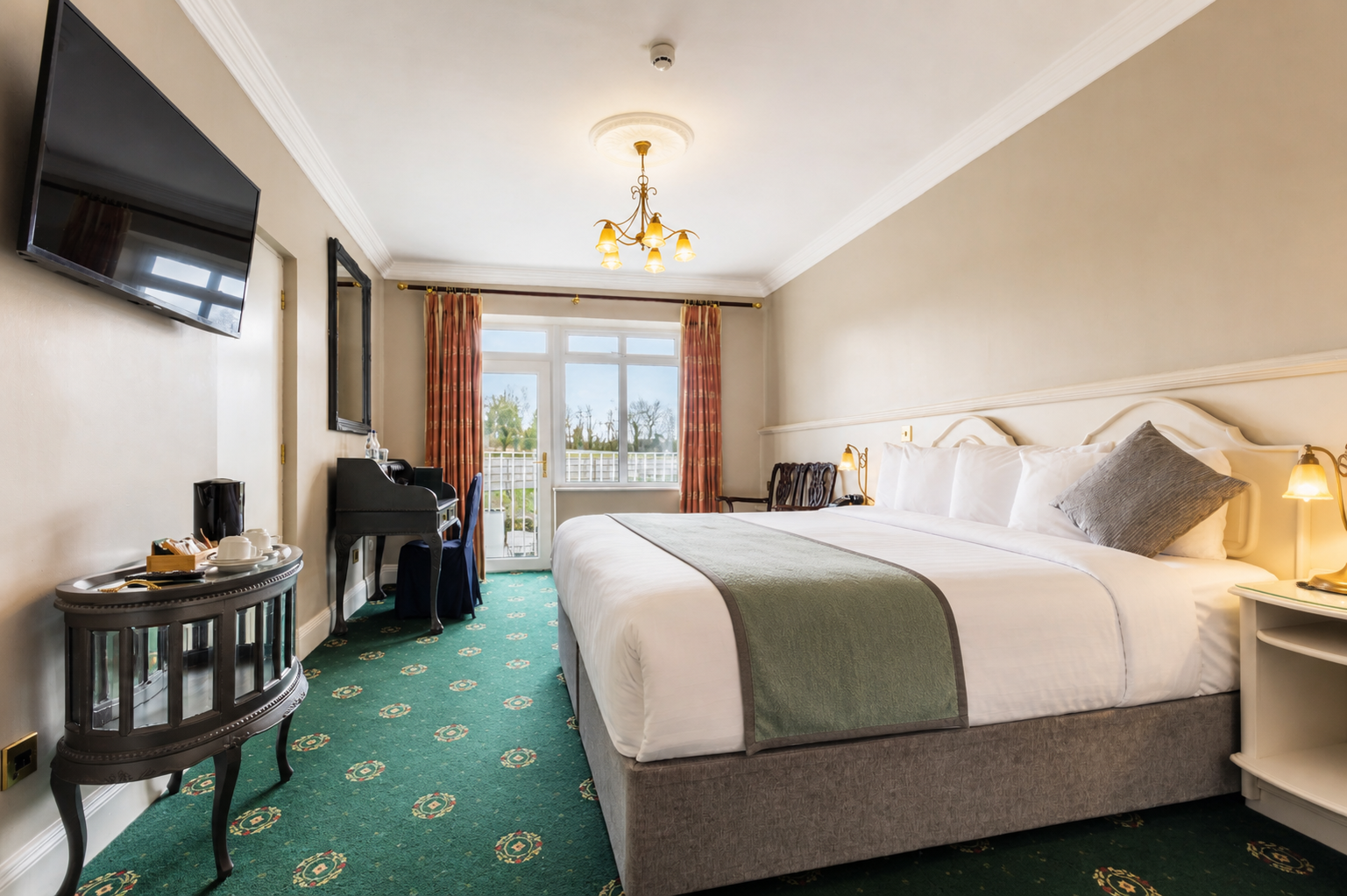 Bright double bedroom with balcony doors at The Lakeside Manor